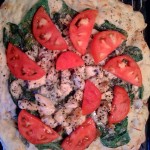 Spinach, chicken, tomato, oregano and parmesan pizza