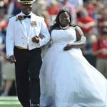 Homecoming Queen Courtney Pearson, right, is escorted by her father Commander Kerri Pearson during halftime of an NCAA college football game between Mississippi and Aubuen in Oxford, Miss., on Saturday, Oct. 13, 2012. Miss Pearson is the University of Mississippi's first African-American homecoming queen.(AP Photo/Oxford Eagle, Bruce Newman)